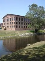 The historic brick paper mill building beside the Kalamazoo River