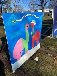 A dinosaur-themed holiday card displayed in Hicks Park
